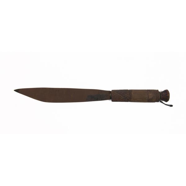 A dagger, with the blade pointing left. It has a brown handle and a rusty blade. There are lines etched into the handle and it has a small loop attached to the handle.