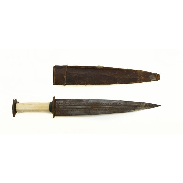 A metal dagger with an ivory handle and a leather sheath pointing to the right. The blade is symmetrical and there are two grooves running the length of the blade. There is a "v" pattern towards the edge of the blade. There are decorative diagonal lines running vertically on the sheath. 
