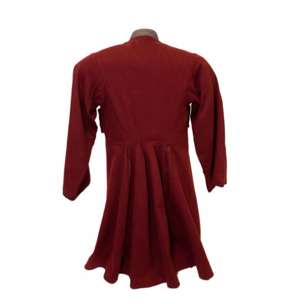 The back of a Cossack uniform made for a child. It is red in colour and is pleated from the waist down. 