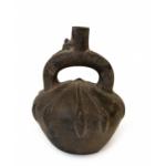 Front side of dark brown stirrup-spout bottle. Decorated with a low-relief, radiating pattern.