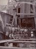 Harry Phillips and his crew posed in front of an oil rig. 